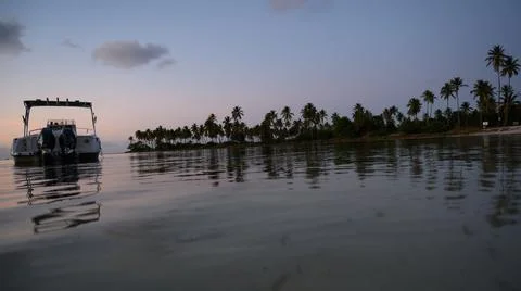 Exotical beach at sun fall in evening time Stock Photos