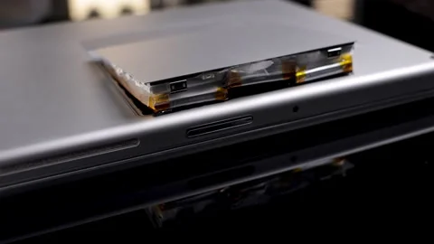 Expanded lithium ion battery fire hazard close up. Notebook battery explosion. Stock Footage 263987264