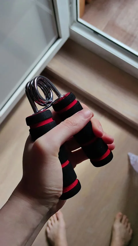 The expander is manual. a hand simulator. a man kneads his fingers. background Stock Footage 236923484