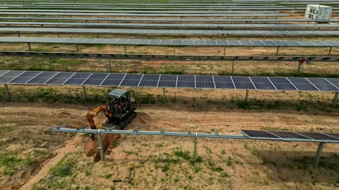 Expanding a solar panel farm by adding more panels - drone pullback reveal Stock Footage 291118179