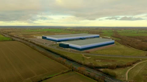 Expanding warehouse complexes operating logistics workflows across industrial Stock-Footage 333580478