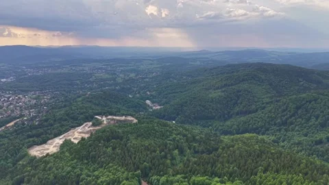 Expansive aerial panorama over forested hills and valleys, quarry ridge, distant 動画素材 345286462