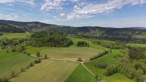 Expansive aerial panorama of patchwork fields, rolling hills, forests, and Stock Footage 342358516