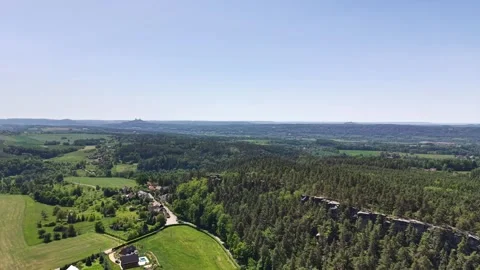 Expansive aerial panorama reveals patchwork fields, dense forests, scattered Stock Footage 346261605