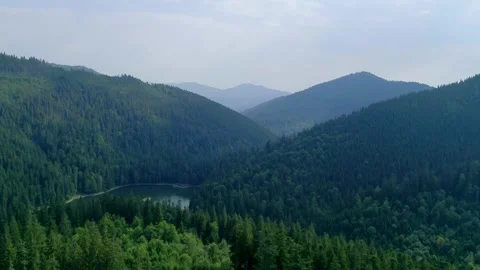 Expansive aerial view of forested mountain valley Stock Footage 327551589