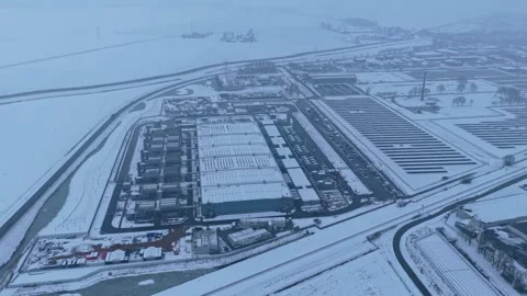 Expansive aerial view of a large, snow covered industrial complex, a modern Stock Footage 328994780