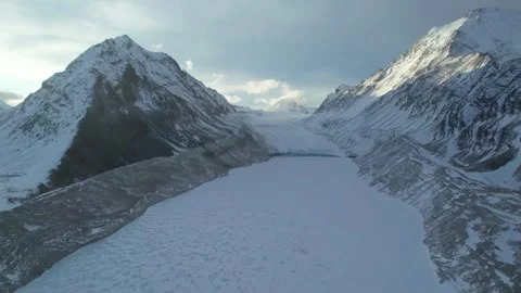 Expansive Aerial View of a Massive Glacier Between Snow Mountains Tibet China Stock Footage 346571028