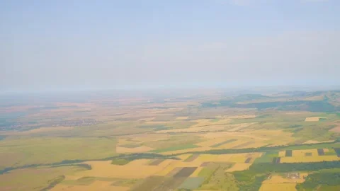 Expansive aerial view of patchwork farmland fields stretching across the ho.. 스톡 동영상 293087291