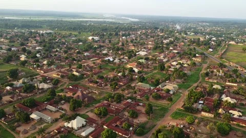 Expansive aerial view showcasing a vibrant rural African community with river Stock Footage 314404440