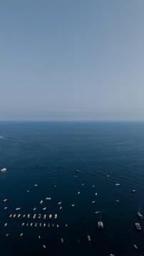 Expansive blue ocean view from above, showing numerous small boats, yachts, and Stock Photos