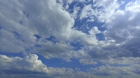 Expansive Blue Sky Filled with Dramatic Clouds, Ideal for Backgrounds and C.. Stock Photos