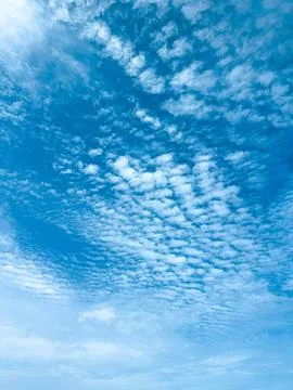 Expansive Blue Sky Filled with Numerous Small White Clouds on a Clear Day Stock Photos