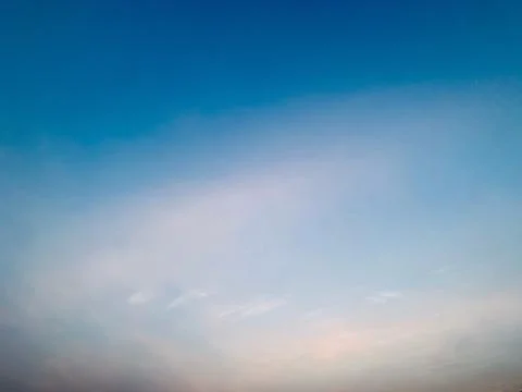 Expansive Blue Sky With Soft Cloud Haze and Luminous Atmospheric Horizon Stock Photos