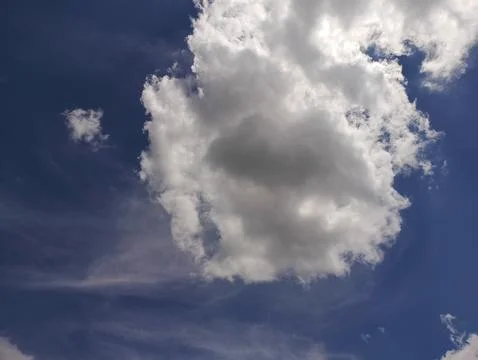 Expansive cloudscape featuring fluffy cumulus clouds against a bright blue sk Stock Photos