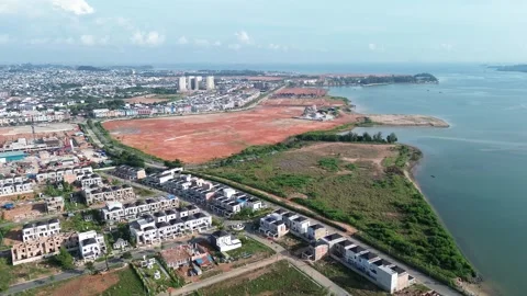 Expansive coastal urban development featuring new housing alongside natural Stock Footage 319608316