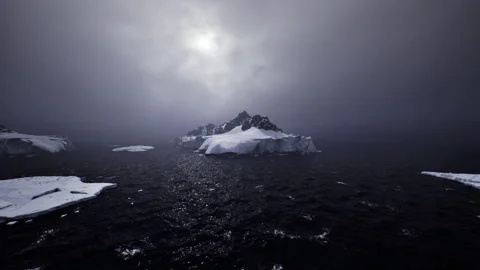 Expansive cold marine environment with floating ice and diffuse sunlight rays 動画素材 334041563