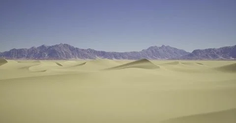 Expansive desert landscape with distant mountains under clear blue sky Stock Illustration
