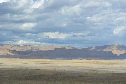 Expansive Desert Landscape Under a Dramatic Sky at Dusk in the Wilderness Stock Photos
