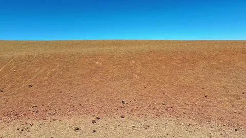 The Expansive Desert Terrain Spanning Beneath a Beautifully Clear Blue Sky That Stock Photos