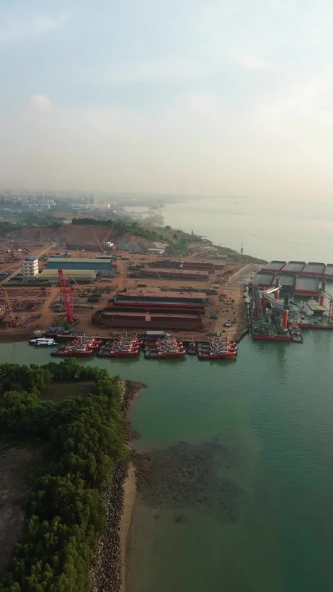 Expansive drone footage capturing a vibrant coastal industrial port with nu.. Stock Footage 337281499