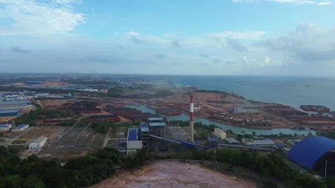 Expansive drone perspective of a coastal energy plant and bustling maritime.. Stock-Footage 337268772
