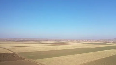 Expansive Farmland Patterns Stretching Toward Distant Horizon Stock Footage 325482282