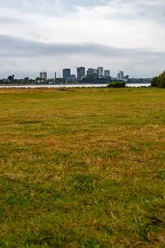 Expansive Field Facing a Distant Urban Skyline Stock Photos