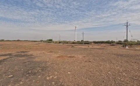 Expansive Flat Arid Terrain Featuring Renewable Energy Windmills and Overhead Stock Footage 342863141