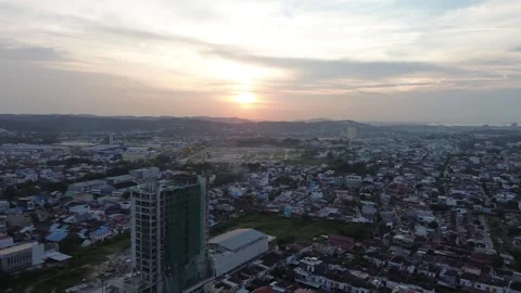 Expansive Golden Hour Cityscape with A Drone's Perspective on Urban Development Stock Footage 320106408