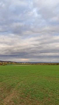Expansive green fields contrast gray clouds Kutna hora, St. Barbaras church Stock Photos