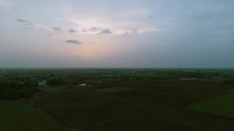 Expansive Green Rural Landscape Under Dramatic Cloudy Sky Captured by Drone Stock-Footage 338226835