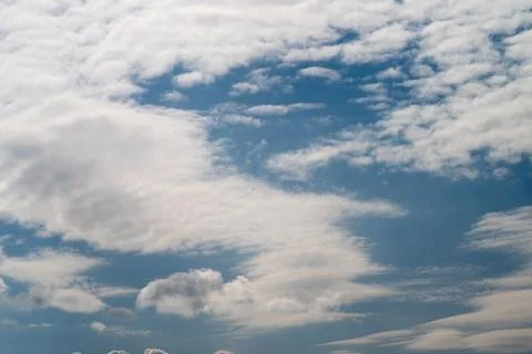 Expansive horizon sky clouds with dramatic shapes and warm highlights, cine.. Stock Photos