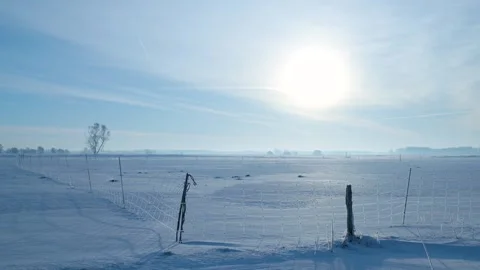 Expansive Icy Plain Under Bright Sky, Windy Snowy Terrain Featuring Distant Stock Footage 327051665