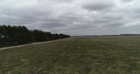 An Expansive Landscape Featuring Cloudy Skies and a Serene Pathway Through Stock Footage 310513151