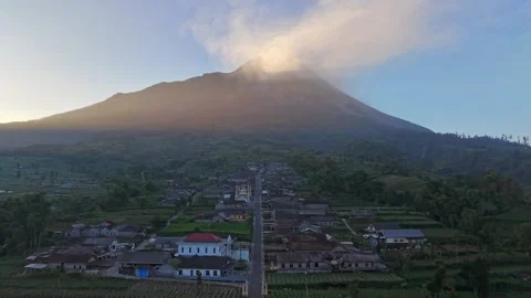 Expansive landscape featuring Mount Merapi above a thriving agricultural Stock Footage 338428805