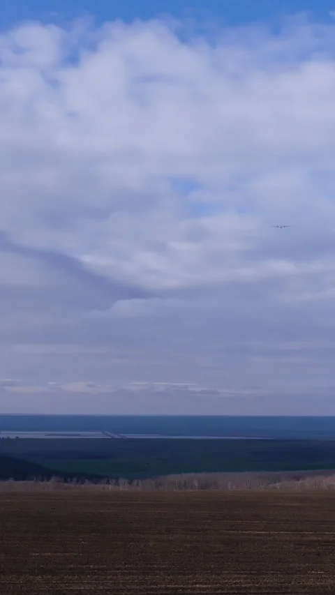 Expansive landscape view showcasing a serene horizon with rolling fields and a Stock Footage 314307510
