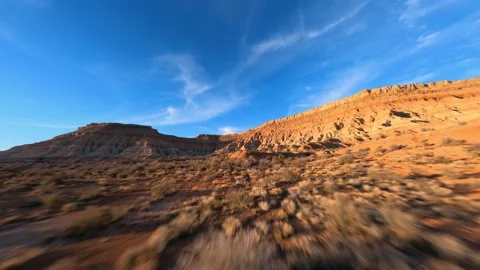 Expansive Large cliffs Desert landscape foliage fast flying over bushes mesa Stock Footage 172119723