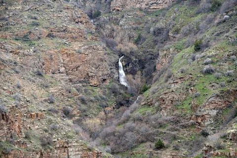 Expansive mountain gorge with subtle waterfall and rocky textures. 스톡 사진