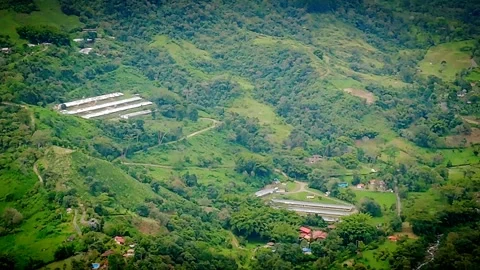Expansive mountain slopes covered in dense forest and scattered farmland Stock Footage 316791207