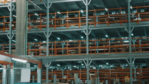 Expansive multilevel warehouse racking filled with pallets and cartons inside an Stock Footage 335861627