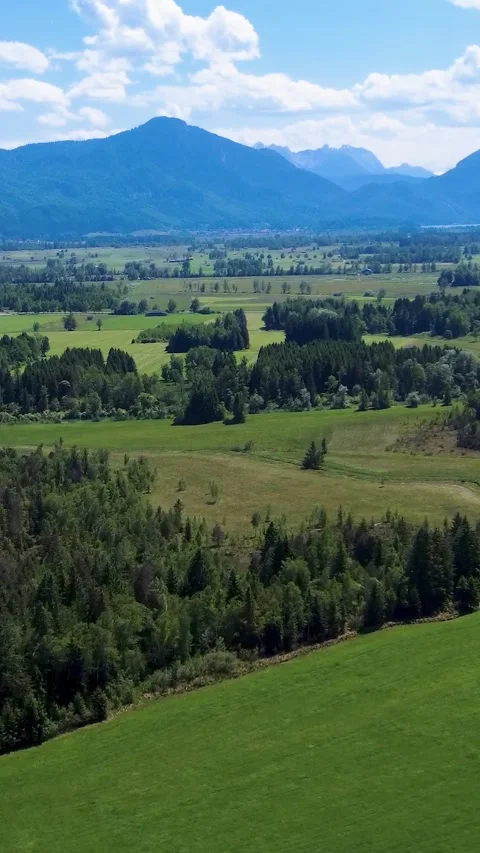 Expansive Natural Landscape With Mountains in the Background and Green Valleys Stock Footage 311112172
