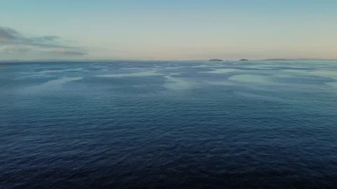 Expansive ocean aerial view with small islands in the distance Stock Footage 113013709