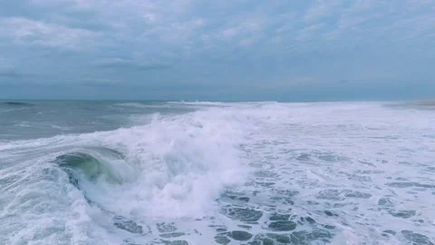 Expansive Ocean Waves under a Cloudy Sky Stock Footage 297468575