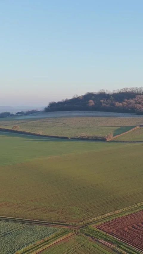 Expansive patchwork fields and gently rolling hills in the rural countryside of Stock Footage 346631827