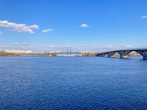 An expansive river under a clear sky, with multiple bridges and a distinctive Stock Photos