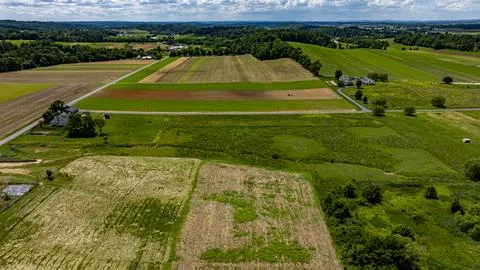 Expansive Rural Landscape Showcasing Fields and Farmland Under a Blue Sky Stock Photos