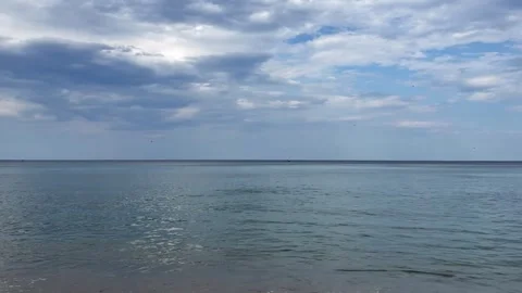 Expansive seascape with tranquil water and textured cloud formations. Open Stock Footage 337104892