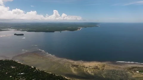 Expansive shoreline with ocean and mountain background. Siargao, Philippines. Stock Footage 321849322