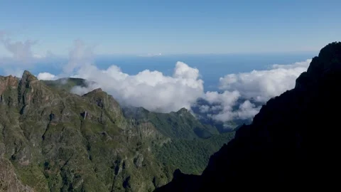 Expansive sky and distant ocean behind rugged mountain range Stock Footage 326362378
