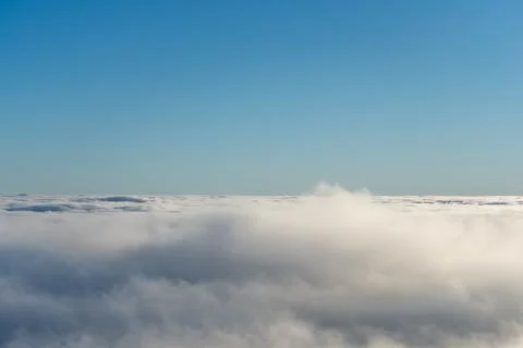 Expansive Sky View Above Soft Clouds with Clear Blue Horizon on a Bright Day Photos